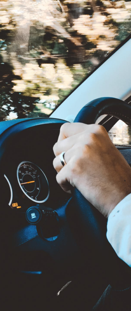 Close Up Of Hands On Steering Wheel