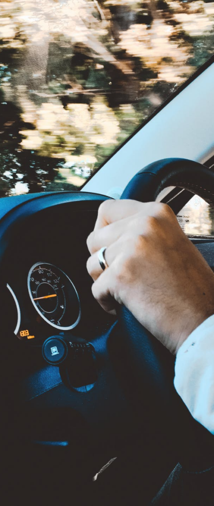 Close Up Of Hands On Steering Wheel
